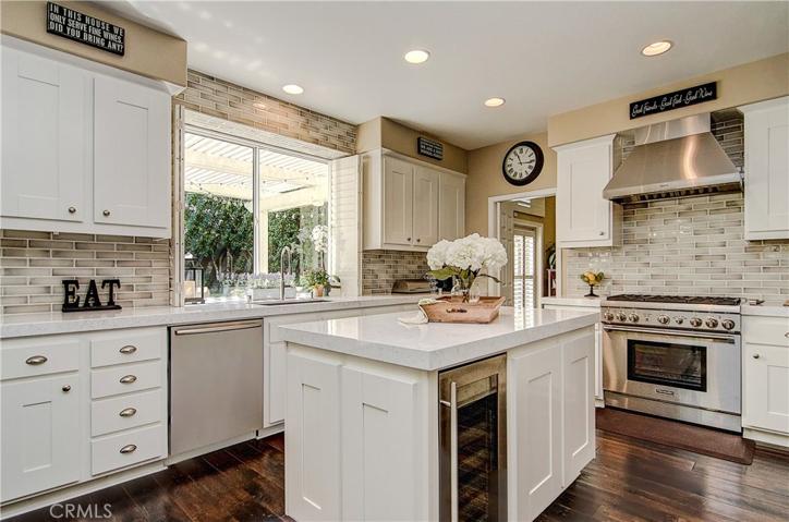Gorgeous kitchen has it all...commercial grade stainless appliances, wine fridge, loads of cabinet and prep space, garden window...and tasteful, designer decor.