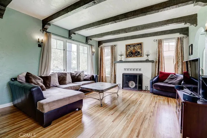 The large fireplace and original light fixtures are some of the best features of this room.