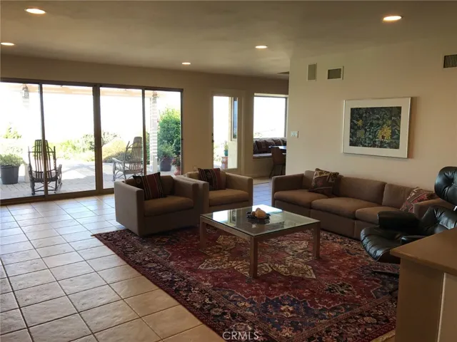 Another view of the family room with panoramic views and beautiful natural light, adjacent to the kitchen and the formal dining room.