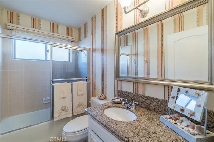 The fourth bathroom is conveniently located between the fourth bedroom and the garage and across the hallway from the laundry area.