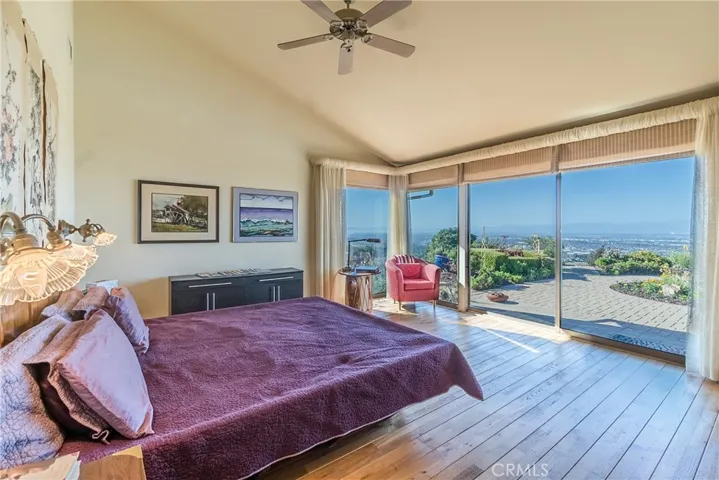 The large Master Bedroom features high ceilings, gorgeous views, and ready access to the backyard, pool, and spa.