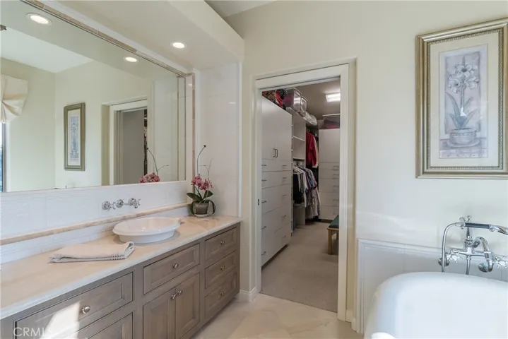 The large walk-in closet has plenty of room for clothes, shoes, linen, luggage, and more.
