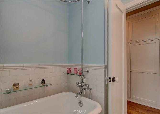Period claw foot bathtub and shower add classic appeal to the room.