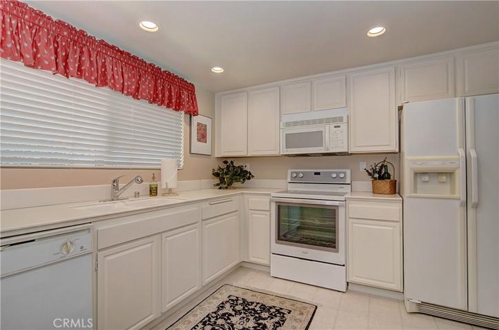 Tile flooring, recessed lighting, and plenty of counter space.