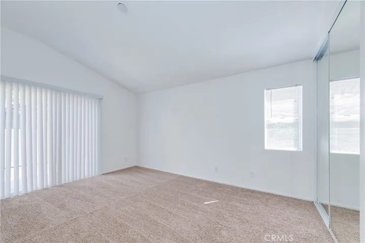 Master bedroom one is roomy with NEW carpet, NEW mirrored closet doors, NEW blinds along with a private patio.