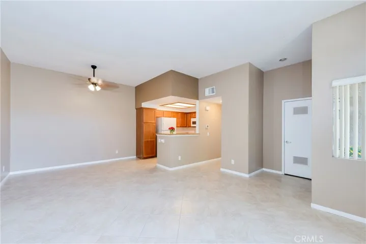 The living room flows into the dining room and kitchen.