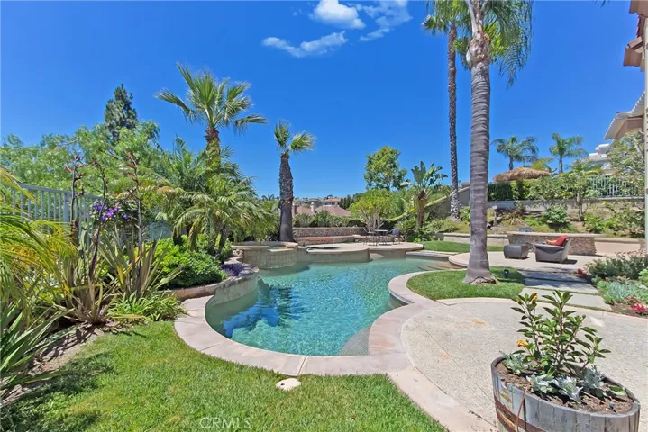 Large rear yard with lush landscaping, pool, spa, fountains and built-in BBQ area