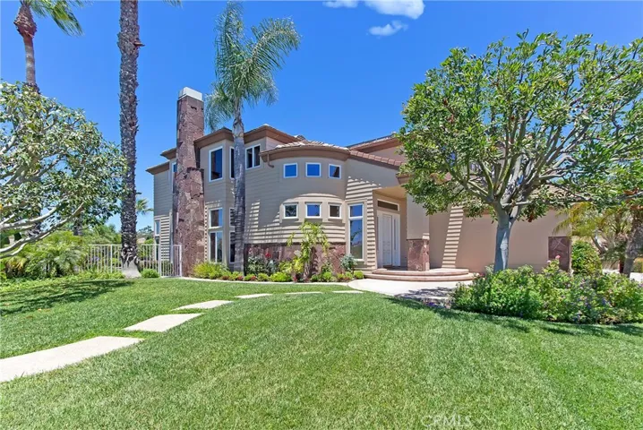 Large front lawn leads up to entry of 11 Emerald Glen