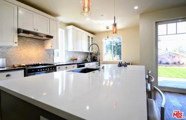 Huge center island with farmhouse SS sink
