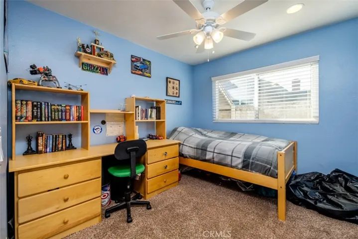 View of the third bedroom with plush carpet and ceiling fan.
