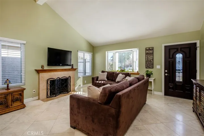 Front Entry and living room with vaulted ceiling and large windows.