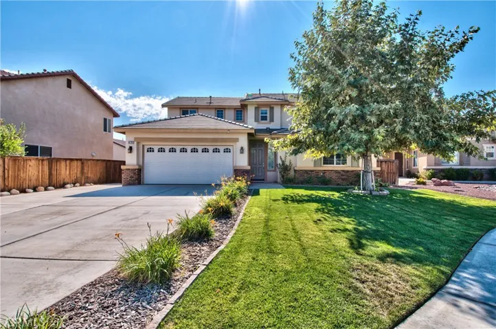 House elevation with front yard lawn.