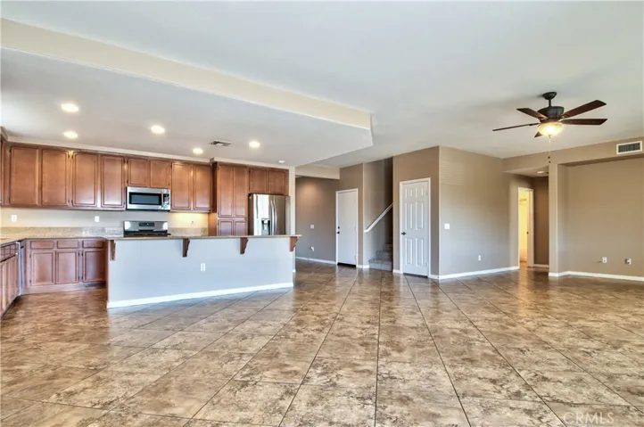 Kitchen open to great room with fireplace.