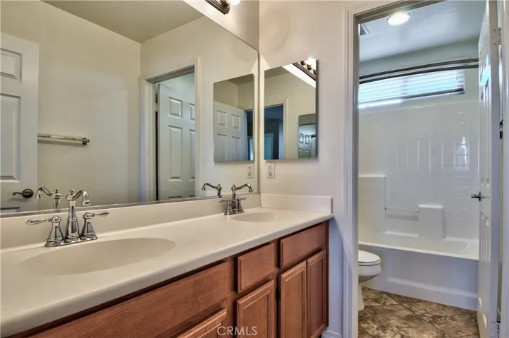 Upstairs bathroom with dual sinks.