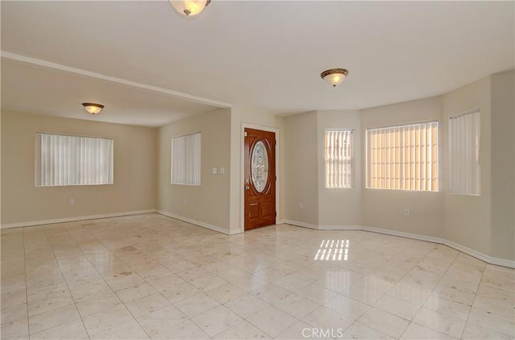 Wow...check out the space in this living and dining area...plus beautiful bay window and front door.