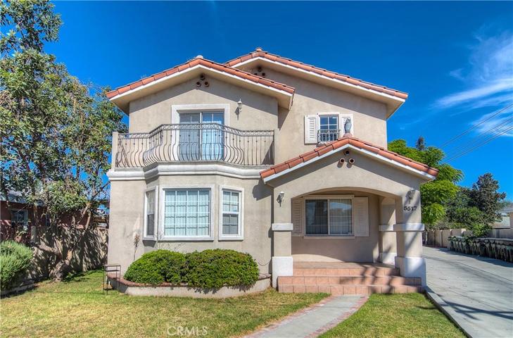 Beautiful curb appeal with authentic mediterranean details...tile roof, iron rails and covered porch. Nice landscape too!