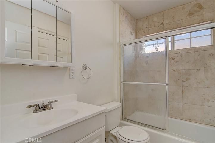 Sparkling upstairs hall bath with lovely stone shower.