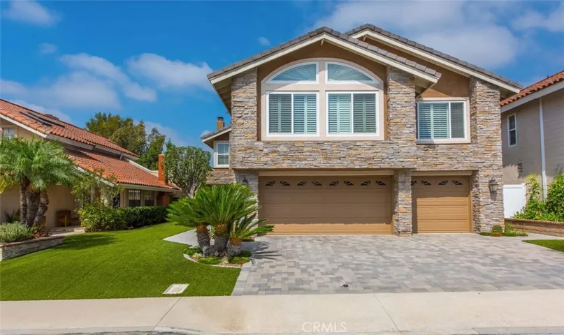 Gorgeous home with custom stone work...3 car garage with a paver driveway...roll up garage doors...Plantation Shutters thru out the house..NO mow artificial turf...Plants and landscape from Rogers gardens. Nothing but the best thru out this home..California Lifestyle at its BEST.