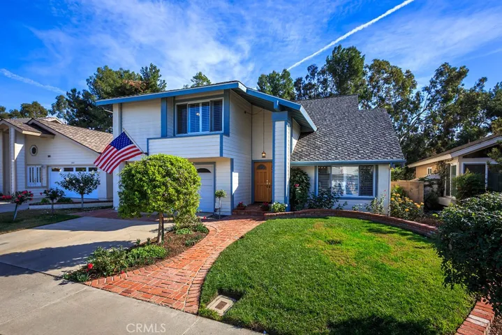 Located on a quiet street, this two story home features four bedrooms with loft and a welcoming front yard, complete with brink entry leading to double entry front doors