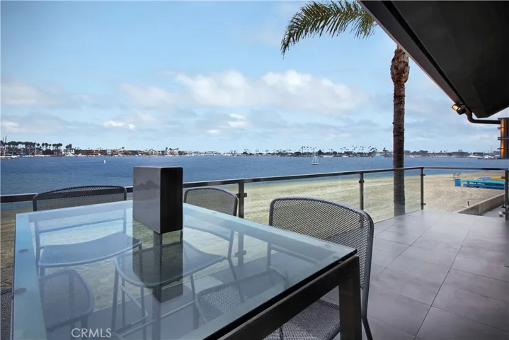 Large Entertaining Picturesque Waterfront Balcony with 180 Degree Bay and Mountain Views and Evening Lighting on the Bay