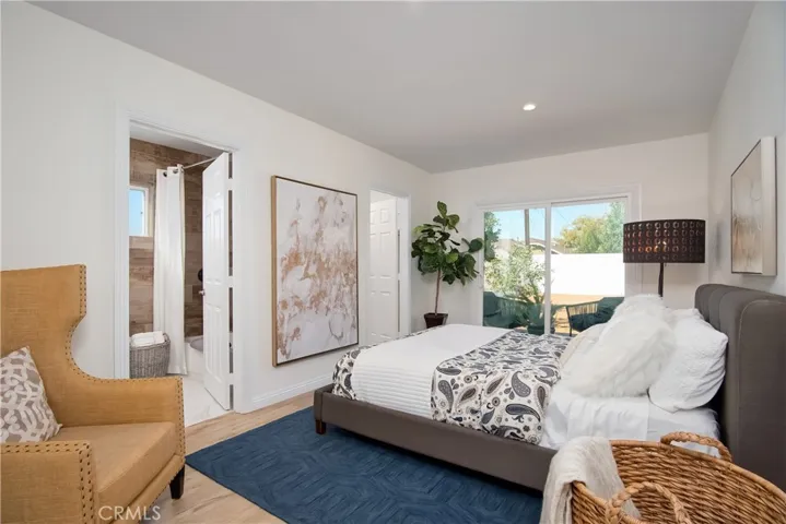 Master bedroom with walk in closet, master bathroom and custom glass slider to the wood decking in backyard