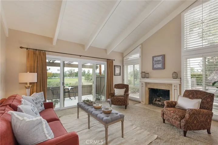 Living Room with Vaulted Ceilings, Floor to Ceiling Windows, Fireplace, and views overlooking the Golf Course!
