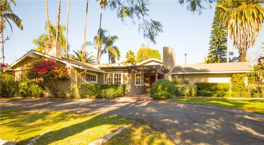 Crescent-shaped driveway leads you off of Tropicana Lane and to your front door