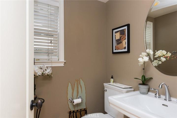 Downstairs bath has pedistal sink and traditional accents.