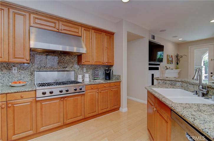 Rich wood cabinetry, commercial grade stainless appliances, stone counters and so much space make cooking a joy in this gourmet kitchen.