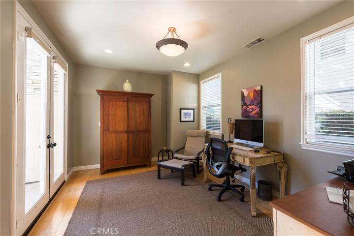 Separate downstairs den with French doors offers many options for home office, library, or could be easily converted to extra bedroom.