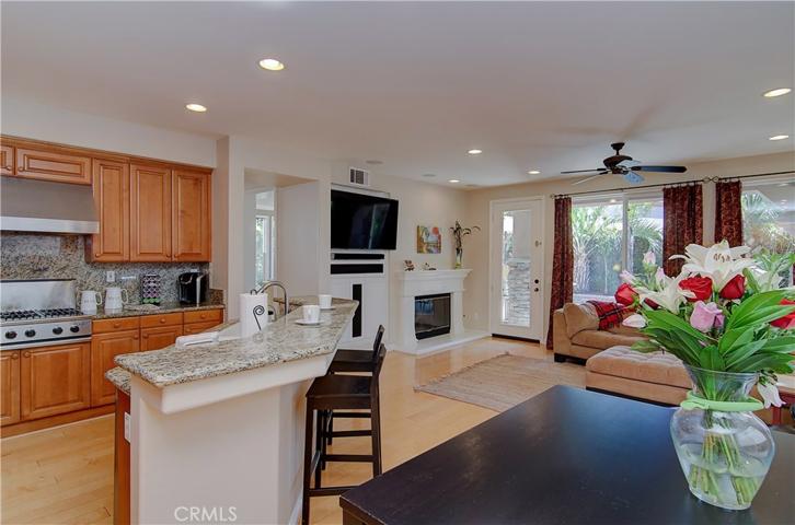Great room offers everything for family time...cozy fireplace, media center, breakfast bar...plus informal dining area...just the right spot for homework...