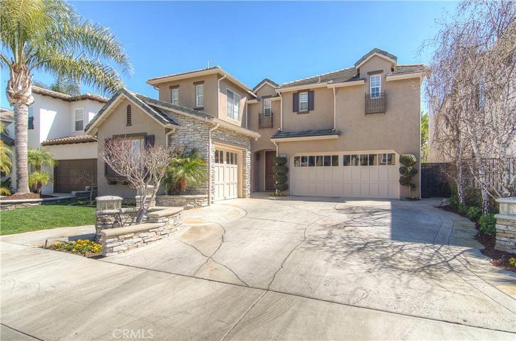 Classic architectural style with shutters, dormers and stone accents create an inviting street presence.