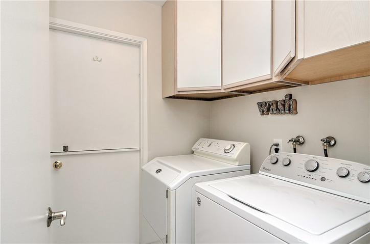 Inside laundry room with overhead storage for your linens and supplies.
