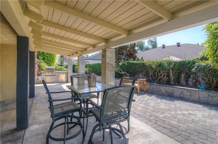 This amazing covered patio with stone columns really expands your living space to the outdoors.