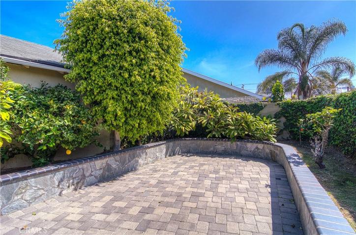 Just the right mix of greenery and hardscape...raised planters give the gardener in you many veggie options.
