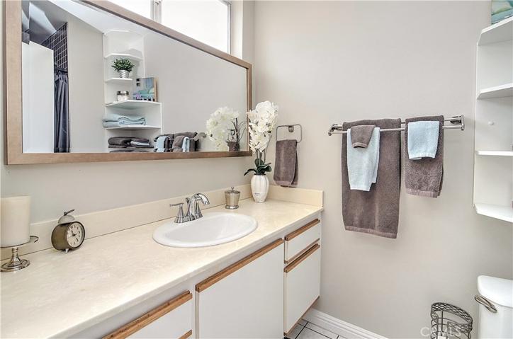 Sparkling master bath has large vanity with storage...plus extra shelving for all your bath accessories.