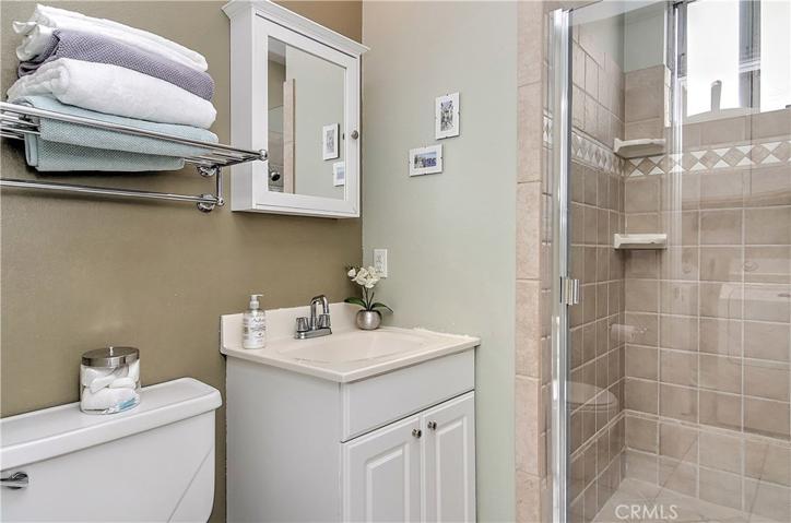 Bathroom #3: Wall hung medicine cabinet, single vanity and open shelving to maximize the storage space.