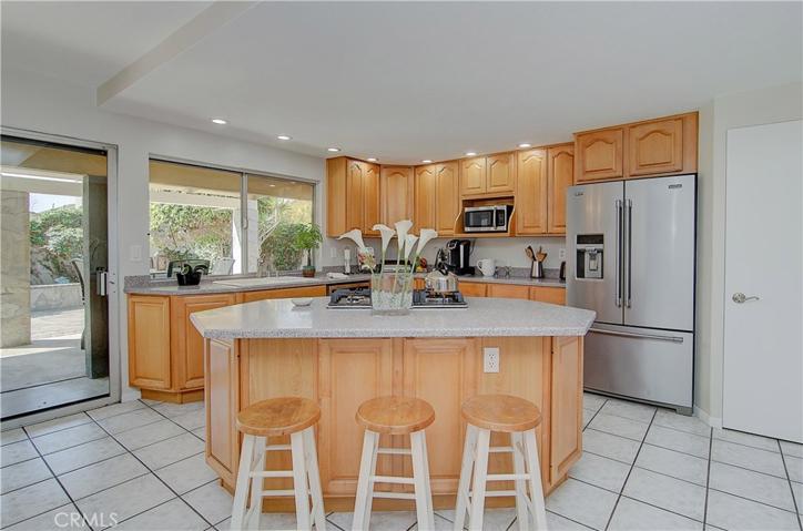 Large kitchen island with plenty of storage. Oh, and another convenient slider to access the backyard and draw in more great light.