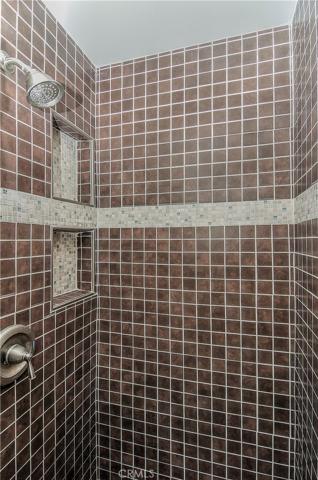 Nice tile detail and shampoo shelves in master shower.