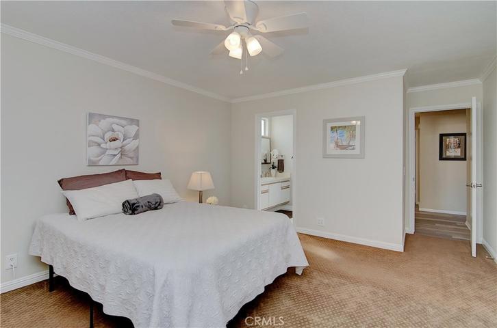 Gorgeous crown molding, baseboards, and designer paint truly make this master bedroom feel tranquil.