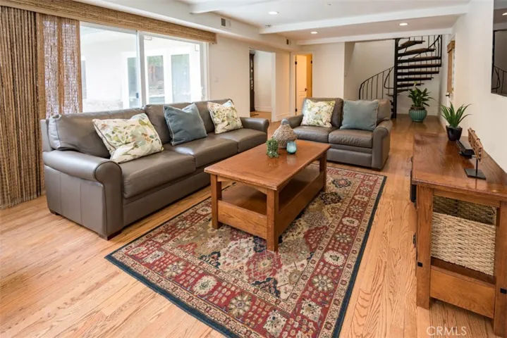 Large family room with Hunter Douglas bamboo shades, hardwood floors, recessed lighting. Full bathroom.
