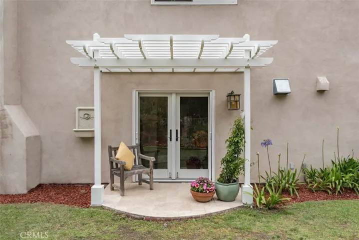 Custom built Pergola outside kitchen leading to side yard.