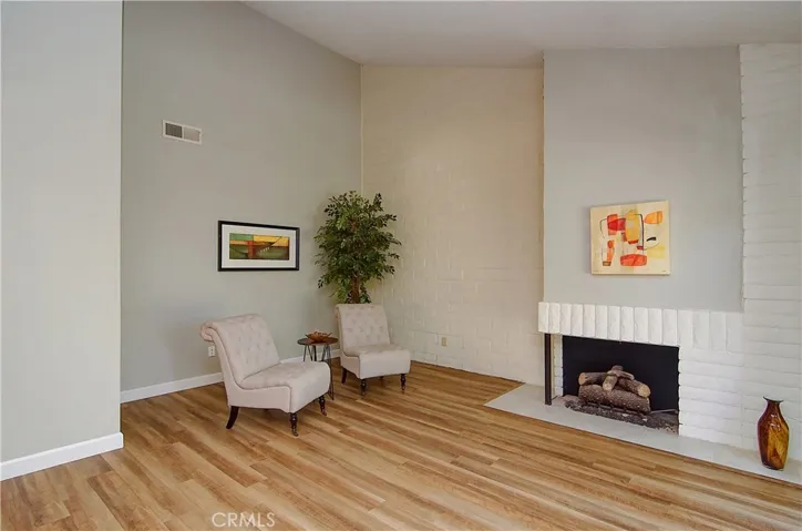 Awesome living space with high ceilings, cozy fireplace and period block details.