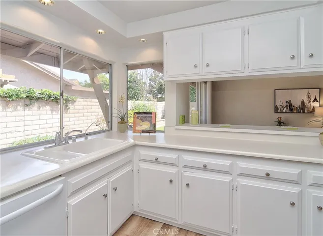 Loads of cabinetry and counter space, plus convenient bar area is the perfect place to hang out with the chef...more walls of glass bring in so much natural light...you'll love this kitchen!