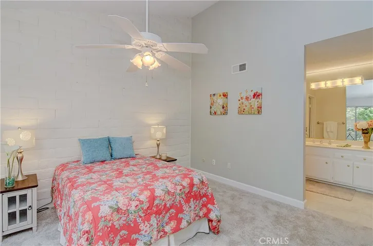 Spacious master suite has block wall detail, high ceiling and plenty of room for king size bed.