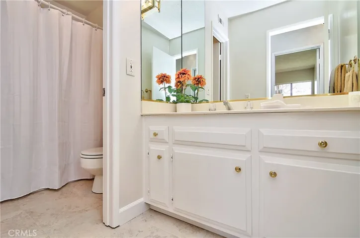 Spotless guest bath has separate vanity and tub areas...perfect for guests or kids.