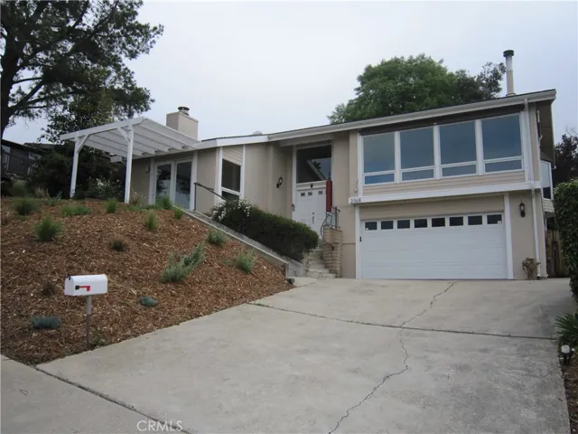 View of the front of the house.  Notice a second entry into the family room.