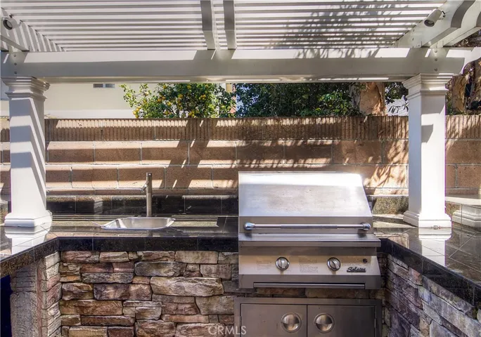Every detail is here with stone accents, granite counters and nice trellis.