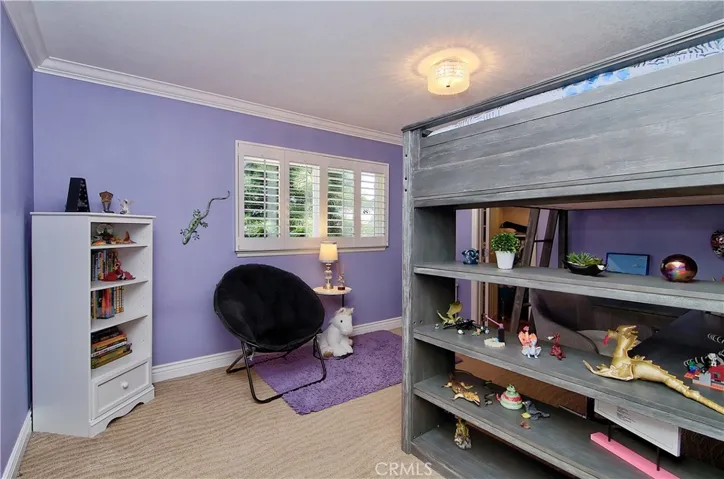 Large secondary bedroom has nice molding details and plenty of space for study and play...walk-in closet too!