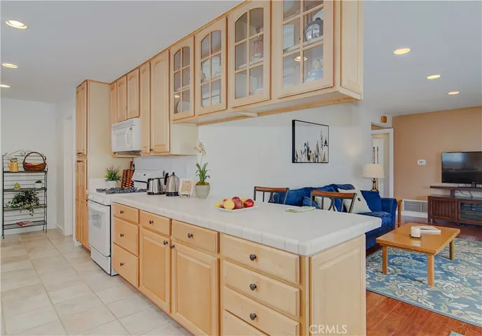 Everyone will want to hang out here...nice glass front cabinets make the perfect place for your prized collections.